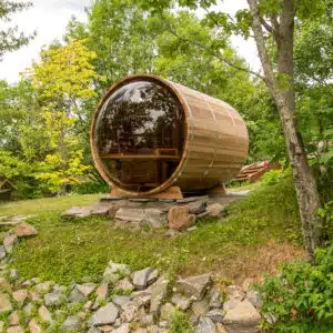 Premium Outdoor Panoramic Barrel Sauna featuring a full acrylic dome window for a luxury garden wellness installation.