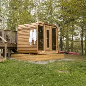 Premium Outdoor Luna Sauna featuring modern curved corners and a panoramic window for a luxury garden installation.