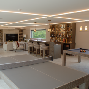 Bespoke steel frame garden room configured into a premium luxury garden bar, featuring an elegant modern beverage lounge, bespoke counter seating, and contemporary architectural glazing for a total garden transformation.
