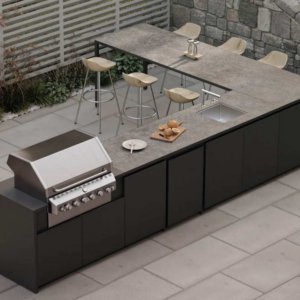 Premium outdoor kitchen featuring an integrated bar seating area, high-end cooking appliances, and a luxury workspace finish for a complete garden transformation.