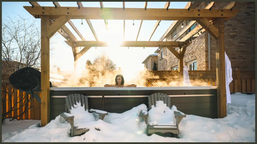 A side-angle view of a premium Hydropool swim spa operating in a modern garden at dusk, showcasing its heavy-duty insulated thermal cover half-retracted to reveal warm, steaming water under elegant LED lighting.