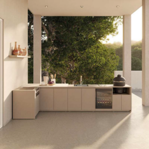 Premium L-shaped outdoor kitchen featuring high-end integrated cooking appliances, extensive preparation worktops, and modern weather-proof cabinetry for a luxury garden transformation.