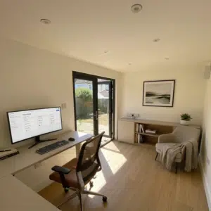 Bespoke steel frame garden room configured into a premium home office, featuring contemporary architectural design and modern glazing for a luxury garden transformation.
