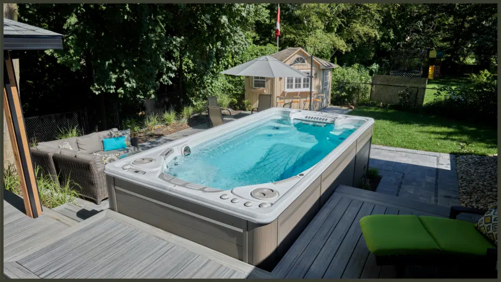 A cutaway technical diagram of a Hydropool self-cleaning hot tub shell, illustrating the pressurized filtration flow path from the surface high-flow skimmer down to the floor vacuum system.