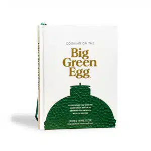 A professional e-commerce product shot of the "Cooking on the Big Green Egg" cookbook, showcasing its vibrant, high-quality cover photography filled with inspiring outdoor grilling recipes.