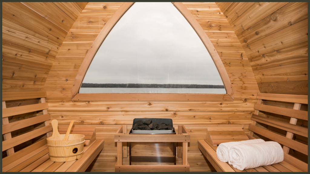 A side-by-side interior viewpoint of two luxury outdoor barrel saunas, one showcasing a rustic wood-burning stone stove filled with logs, and the other featuring a clean, minimalist digital electric heater unit mounted on a timber wall.