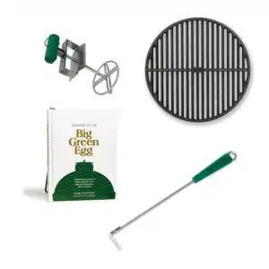 A professional e-commerce product shot of the signature Big Green Egg Essential Accessory Pack, displaying key foundational upgrades including the convEGGtor, an ash tool, and a heavy-duty grid lifter arranged neatly.
