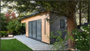A luxury completed garden project in Hadley Wood, Barnet, featuring a contemporary timber-clad garden room building positioned alongside a premium sunken hydrotherapy hot tub.