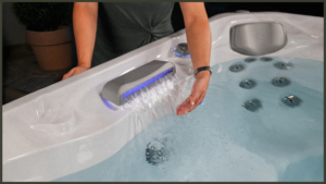 A clean and professional line-art graphic representing a 'Water Chemistry Maintenance Guide', featuring a minimalist design of a water droplet hovering over a balanced chemical scale with sparkling clean icons, symbolizing crystal-clear, safe spa water.