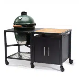 A professional e-commerce product shot of the Big Green Egg Modular Nest and Expansion Cabinet system for the Large EGG, showcasing the heavy-duty powder-coated steel frame holding the Large EGG alongside the matching weather-resistant storage cabinet.