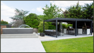 A luxury completed backyard project in Ilford, Redbridge, showcasing a premium built-in outdoor kitchen, a modern bespoke aluminium pergola, and an integrated Hydropool swim spa set within a landscaped garden.