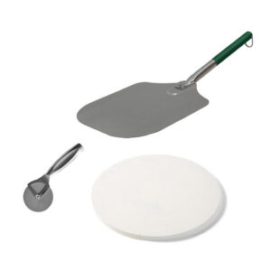 A professional e-commerce product shot of the Big Green Egg Pizza Pack, showcasing the thick ceramic baking stone, a heavy-duty aluminium pizza peel with a comfortable handle, and a professional rolling pizza cutter arranged neatly.