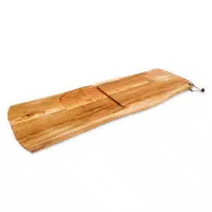 A professional e-commerce product shot of a premium Teak Slather Serving Board, showcasing its sleek, elongated design, rich golden-brown grain patterns, and comfortable integrated handle.